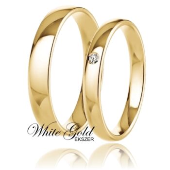 sarga_arany_karikagyuru_123 Sárga arany karikagyűrű pár egy kővel díszített női gyűrűvel Letisztult, klasszikus formavilágú sárga arany karikagyűrű-pár, amely az időtlen eleganciát testesíti meg. A női gyűrűt egy apró, mégis ragyogó kő díszíti, finom fényt adva a sima, fényes felületnek. A férfi gyűrű egyszerű, nemes megjelenése tökéletesen kiegészíti párját.