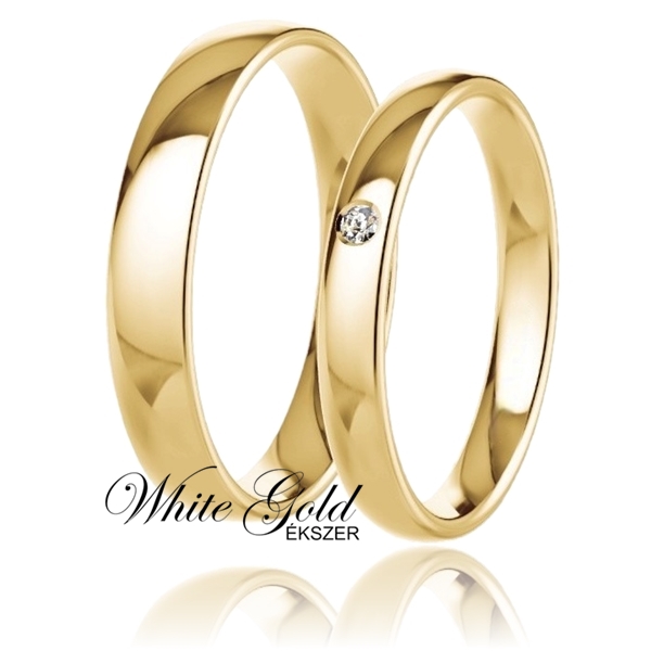 sarga_arany_karikagyuru_123 Sárga arany karikagyűrű pár egy kővel díszített női gyűrűvel Letisztult, klasszikus formavilágú sárga arany karikagyűrű-pár, amely az időtlen eleganciát testesíti meg. A női gyűrűt egy apró, mégis ragyogó kő díszíti, finom fényt adva a sima, fényes felületnek. A férfi gyűrű egyszerű, nemes megjelenése tökéletesen kiegészíti párját.