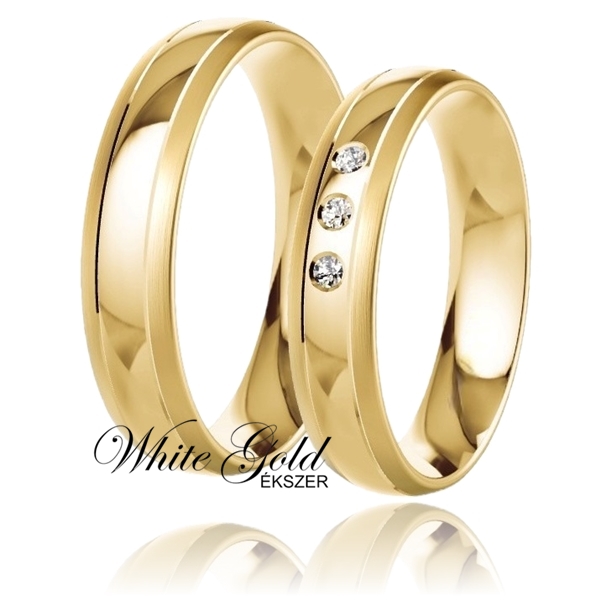 sarga_arany_karikagyuru_88 Klasszikus sárga arany karikagyűrű pár három kővel Ez a sárga arany karikagyűrű-pár a klasszikus eleganciát képviseli, melyet a női gyűrű három ragyogó köve tesz különlegessé. A finoman ívelt forma és a letisztult vonalak időtálló megjelenést biztosítanak, így ideális választás mindazok számára, akik az örök eleganciát keresik.